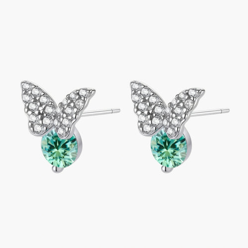 Sterling silver butterfly stud earrings with crystal wings and mint green center stones on cream background.