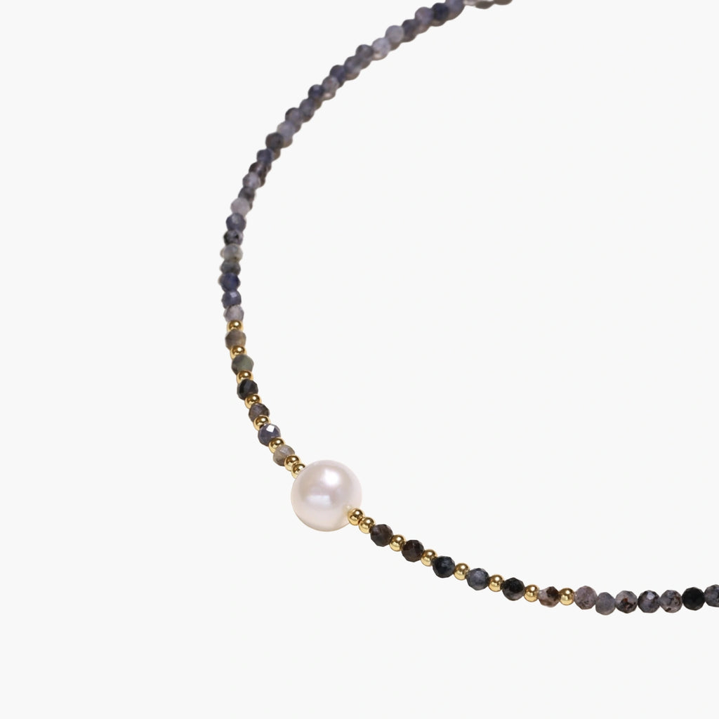 Dainty necklace with faceted purple iolite beads, gold vermeil accents, and central pink-white freshwater pearl.