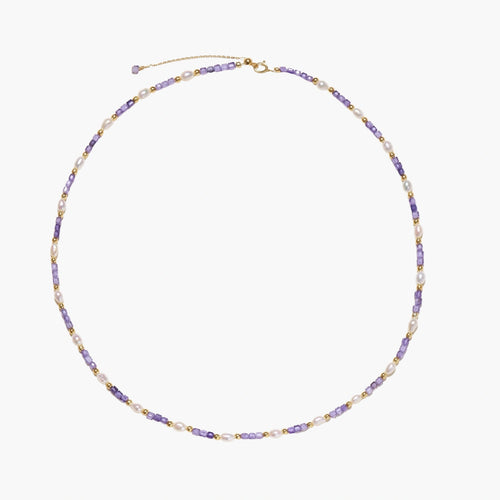 Delicate 18K gold vermeil necklace with alternating lavender zirconia beads and white freshwater pearls on cream background