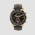 Black watch with brown leather strap on a light gray background