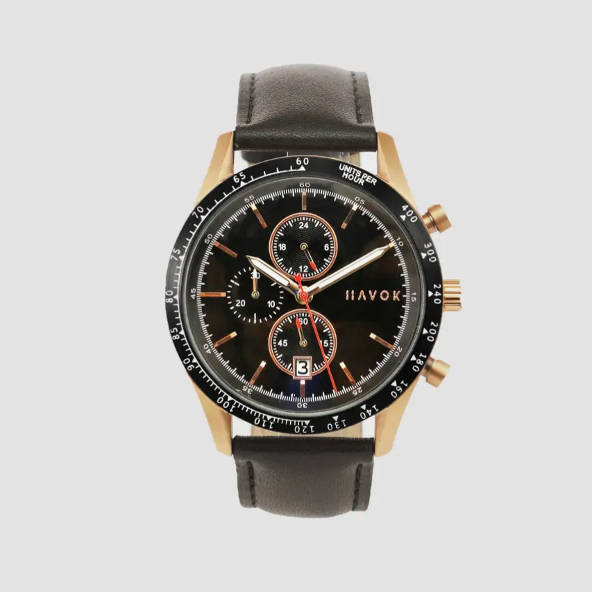 Black watch with brown leather strap on a light gray background